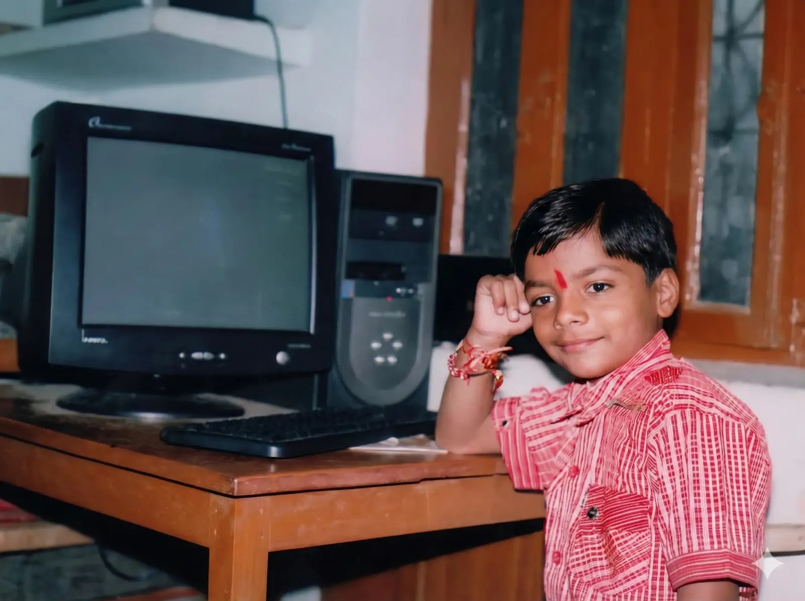 Jagesh as a child sitting at a desktop computer