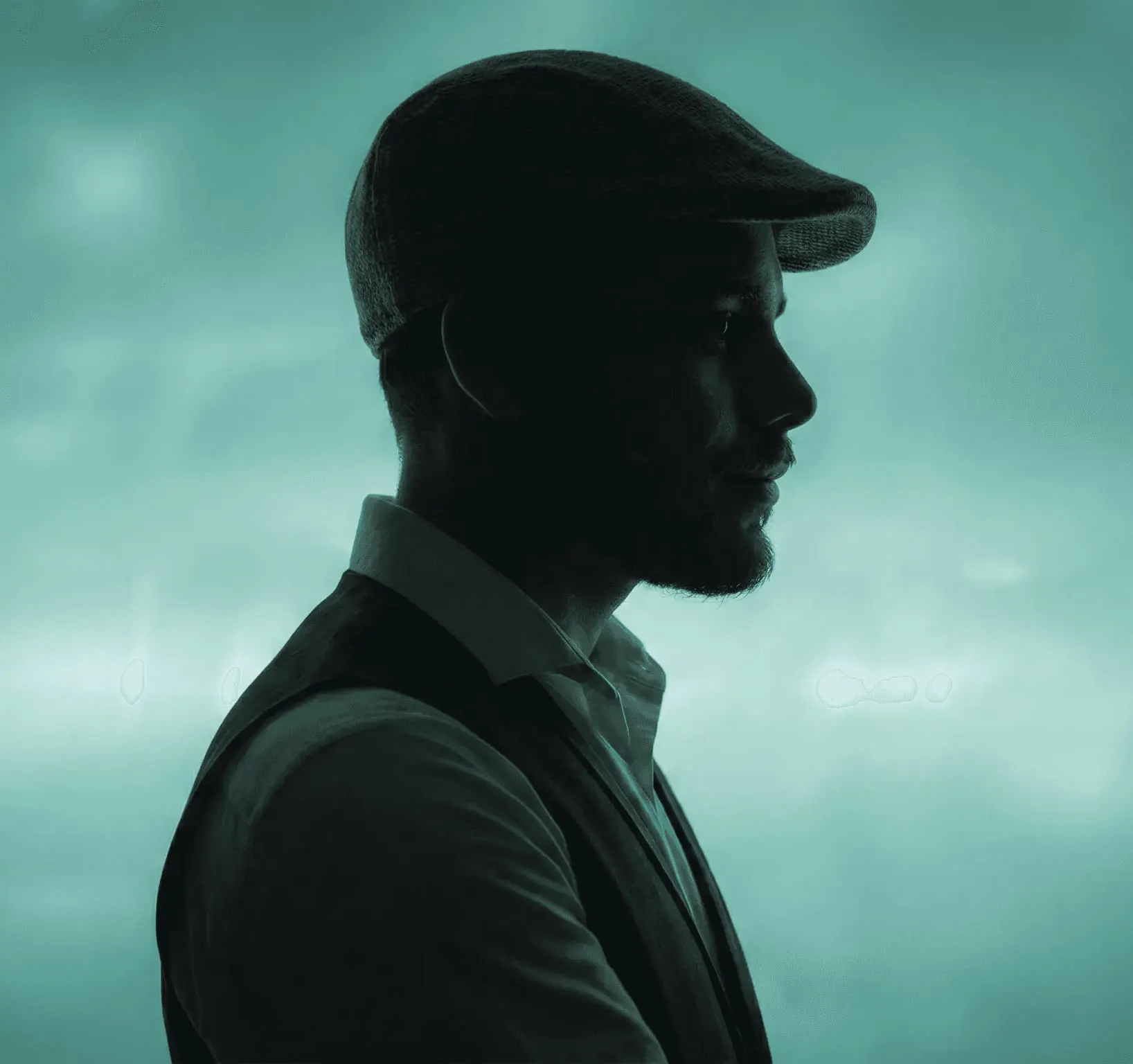 Jagesh Pandey in profile, wearing a flat cap